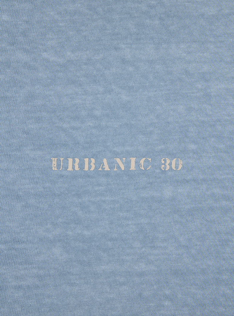 Recycled cotton polo shirt with vintage-inspired URBANIC logo print on the back.