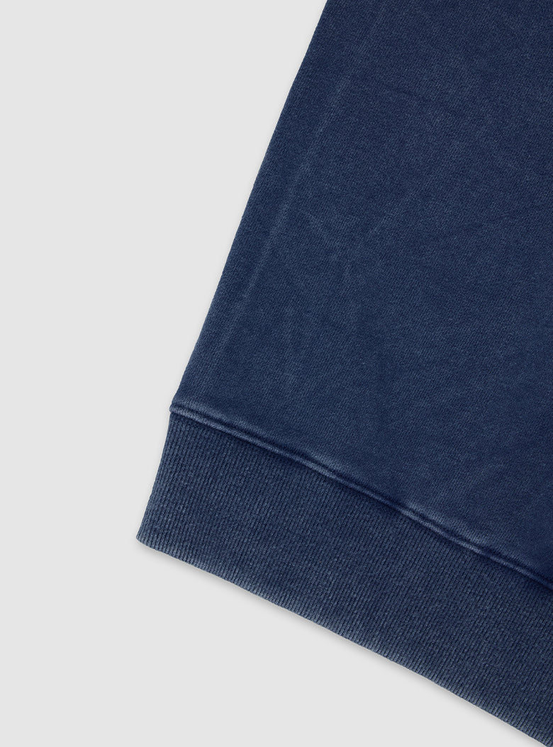 Mineral-washed cotton piece with an uneven, mottled color.