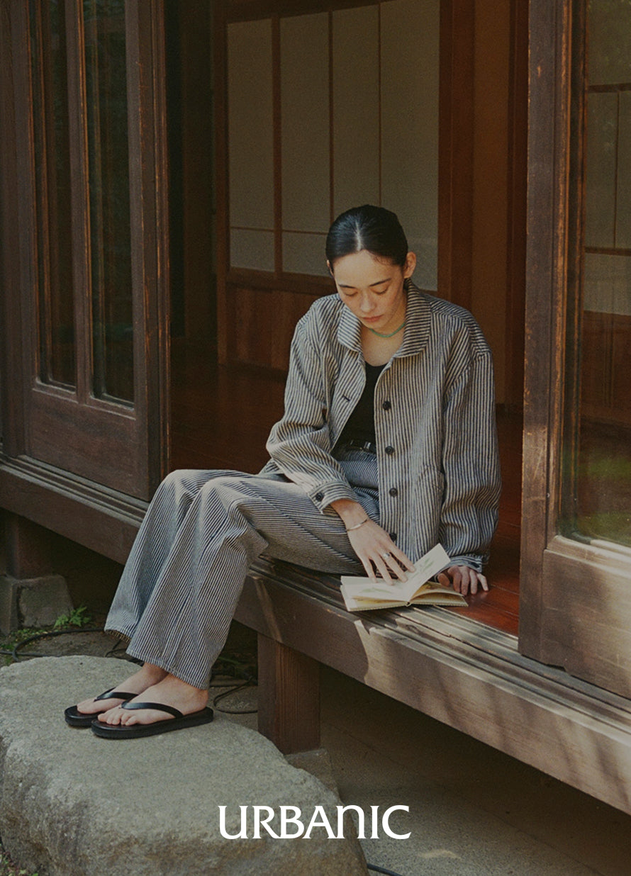 A relaxed-fit navy stripe linen jacket offering a timeless, understated elegance for casual styling