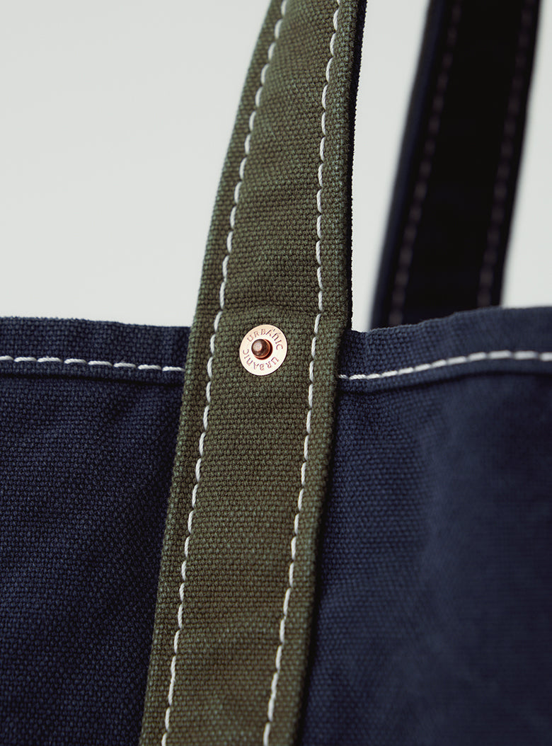 Bag with brass-tone rivets and vintage print lining