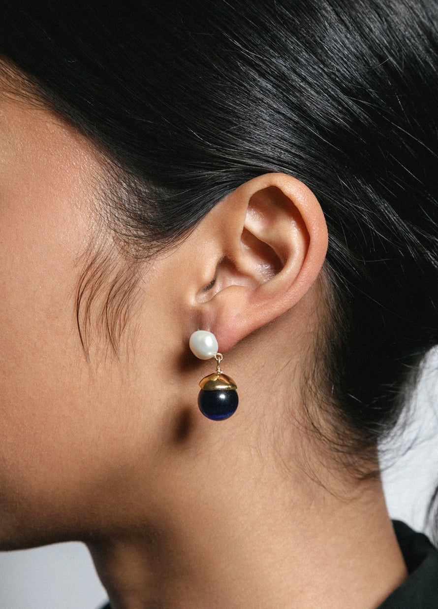 Sculptural pearl earrings accented with luminous blue beads