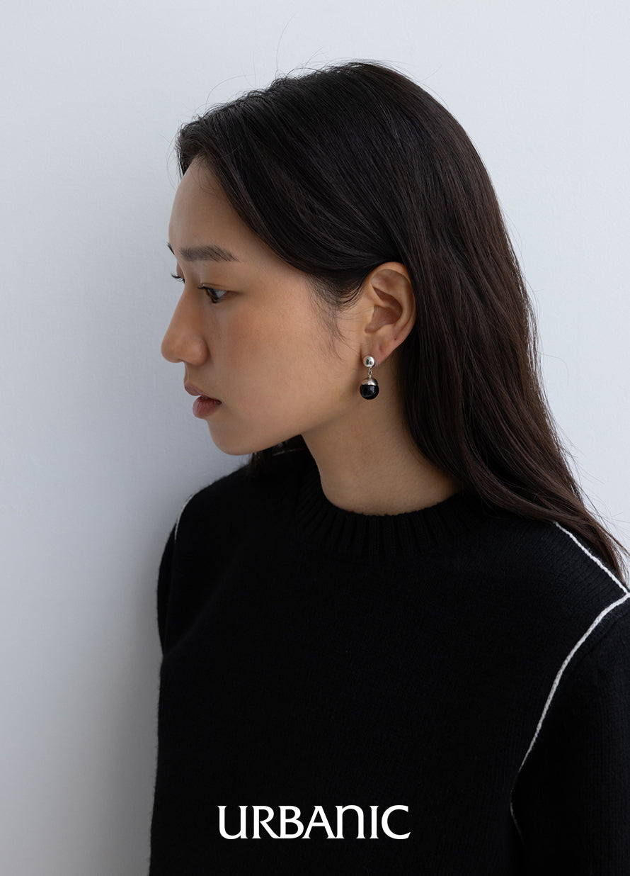 Sculptural drop earrings with polished black onyx and silver caps