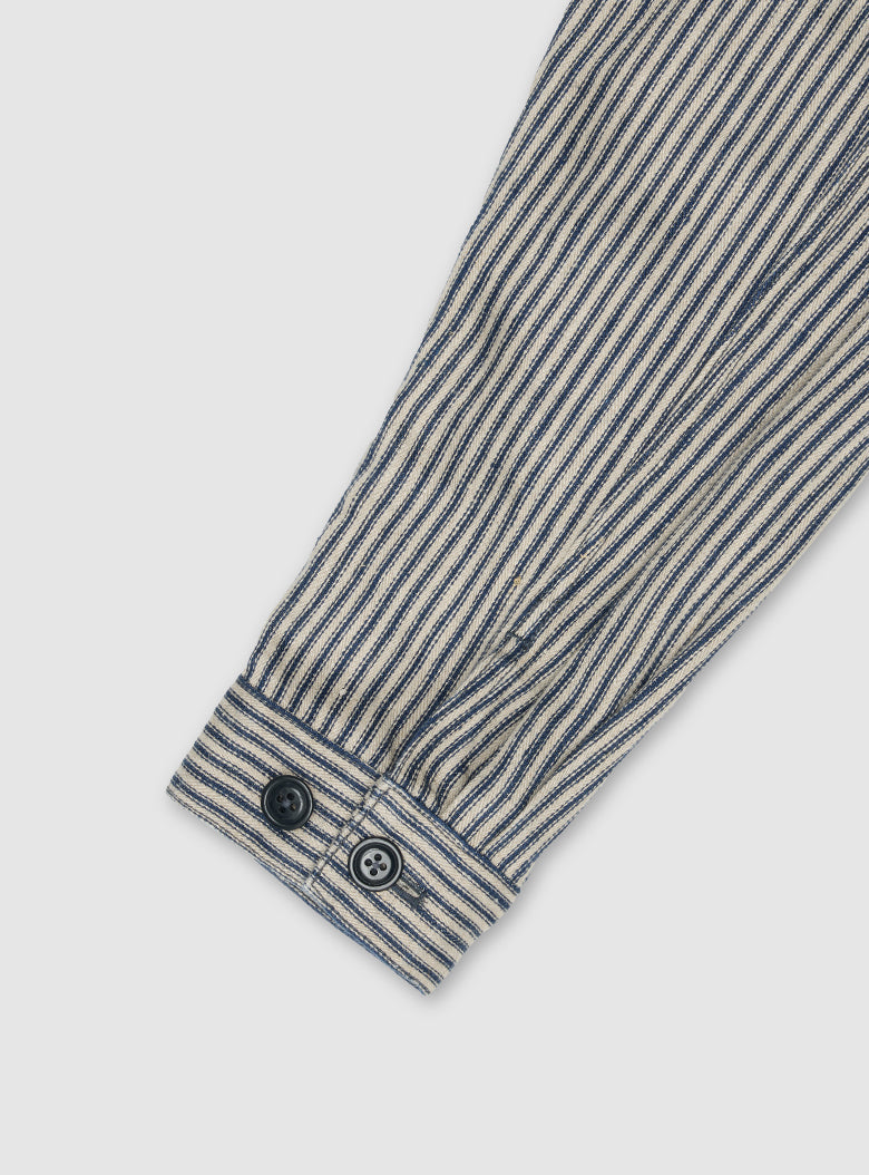 Classic workwear-inspired details on a lightweight linen jacket, blending functionality with elegance